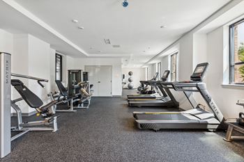 A gym with treadmills and other exercise equipment
